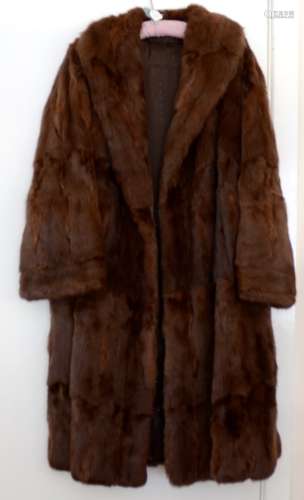 A lady's vintage three quarter length brown fur coat, with a black silk lining highlighted with