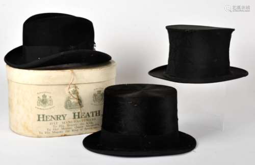 A collection of top hats, including an opera example, two felt examples, one in toleware box, a