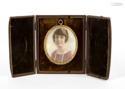 A 20th Century gouache on ivory miniature of a young woman, unsigned, within a gilt oval frame,