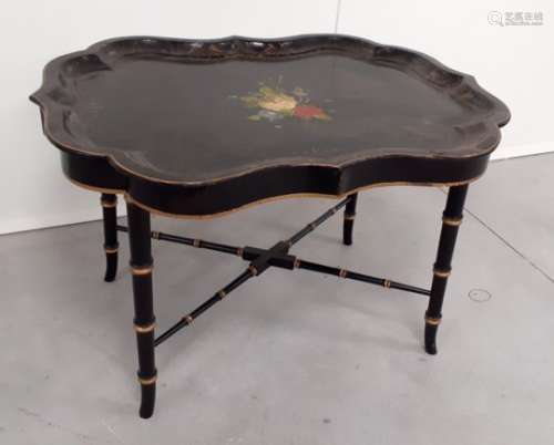 A tray top table, 19th Century black papier mâché tray, shaped gallery with gold pinstriping to