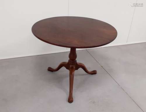 A circular Georgian mahogany tilt top table, turned column with bird cage, raised on shaped tripod