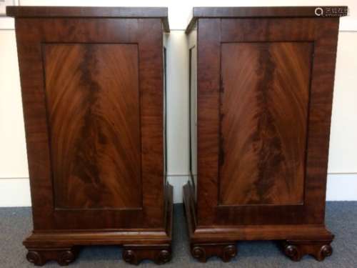 A pair of Willian IV mahogany pedestal cabinets, each with a figured mahogany panelled door and side