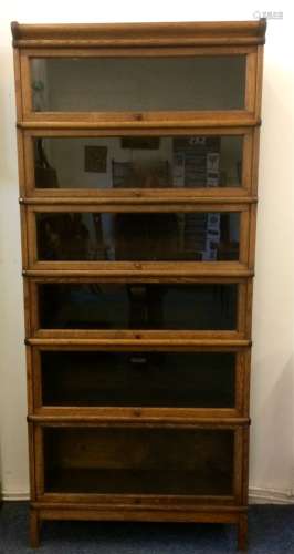 An oak globe wernicke bookcase, six sections with glazed up and over doors and metal trimmings