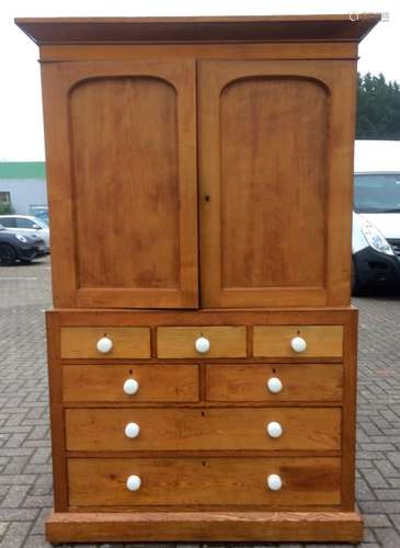 A 19th Century ash linen press, two arched panelled doors with ceramic handles to the top section