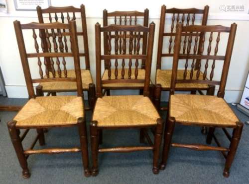 A set of six antique elm ladder back chairs, with spindled decorations to the backs and rushed seats
