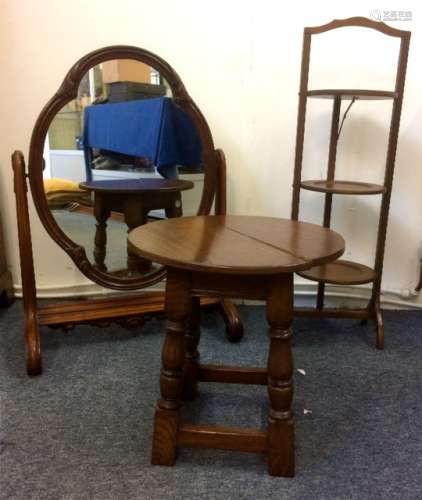 A 19th Century mahogany swing mirror, sold with a Mahogany three tier cake stand and an oak circular