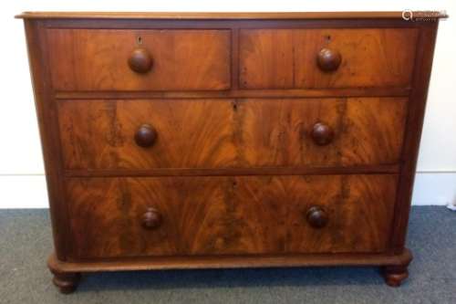 A 19th Century mahogany chest of drawers, two short over two long drawers, rounded corners raised on