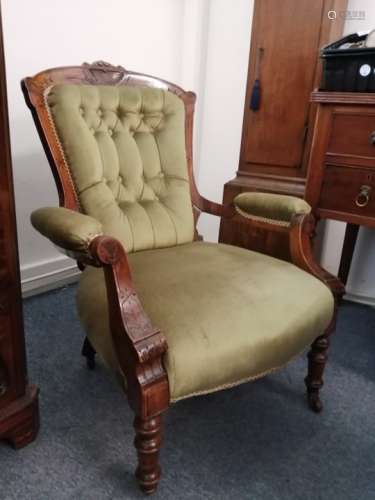 An antique upholstered chair, with carved back, upon castors appears in relatively good order i.e.