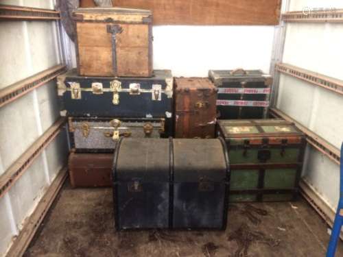 Eight early-mid 20th Century travel trunks, of various shapes and sizes, with metal bindings and