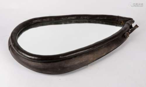 An antique horse collar mirror, with a leather edging, height 67cm