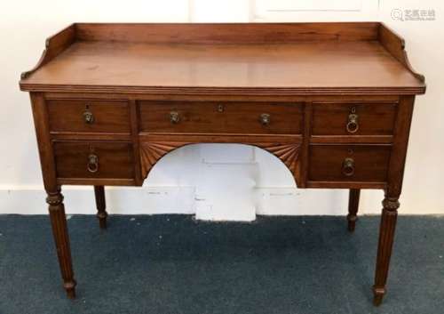 A late Victorian mahogany desk, having gallery to top, cracked top, with drawers and knee hole on