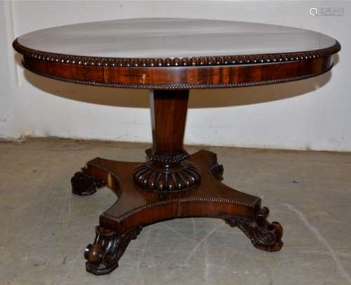 A William IV rosewood breakfast table, carved gadroon edge to top supported on a tapering facetted