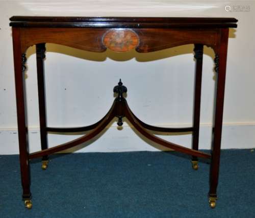 An Edwardian satinwood and mahogany card / bridge table, the top having a figured mahogany oval to