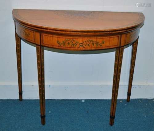 An Edwardian period Sheraton revival satinwood painted demi lune card table decorated with floral