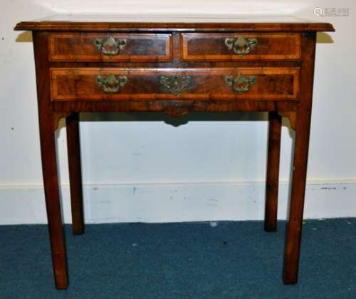 A 19th Century walnut lowboy, cross banned top with moulded edge, two short over one long drawer,