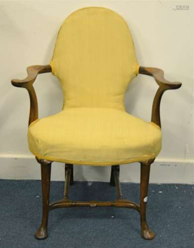 A Victorian elbow armchair in walnut, with upholstered seat and back, once rattan