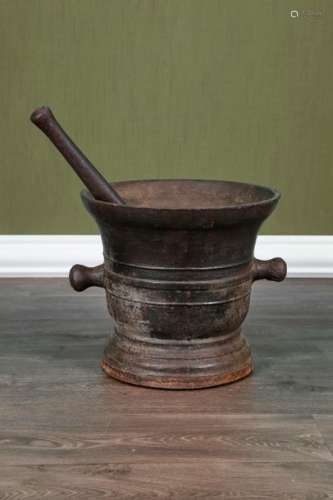 Large mortar and its pestle \n \nMade of cast iron w…