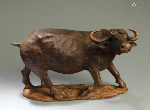 A Carved Wooden Cow Figurine