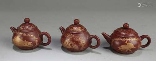 A Group of Three Zisha Teapots