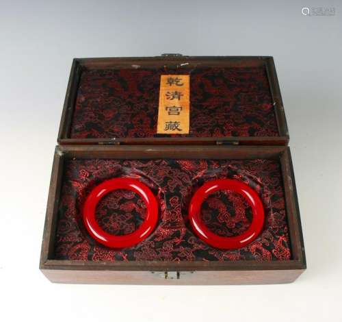 PAIR OF DYED RED JADE BANGLES IN PRESENTATION BOX