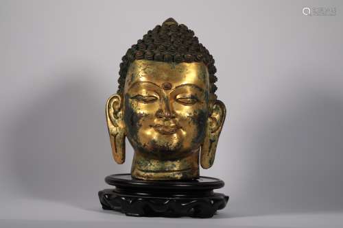 Copper gilded Buddha head in the mid-14th century