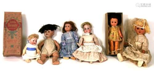 A group of bisque headed, composite and early plastic dolls.