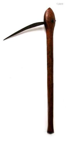 A 19th century Congolese fighting axe. Having a decorated axe head on a decorated hardwood shaft.