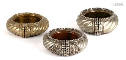 Three slave bangles, later converted to pin dishes (3).