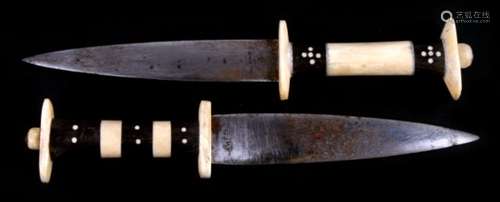 Tribal Art: Two Ethiopian daggers with ivory and ebony sectional handles. 25.5cm 10 inches.