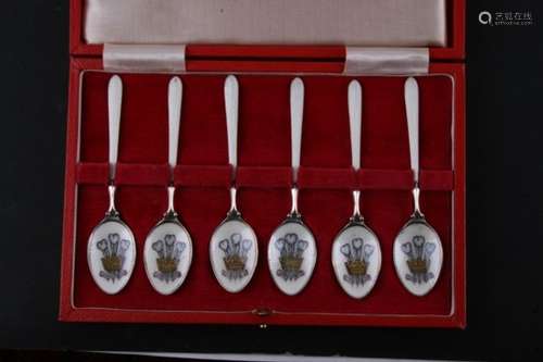 A cased set of six silver and enamel coffee spoons with Prince of Wales feathers crest to the bowls,