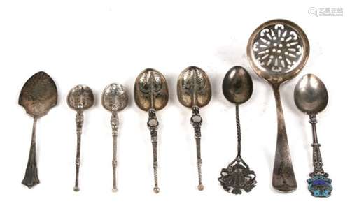 A quantity of silver spoons including a sugar sifter.