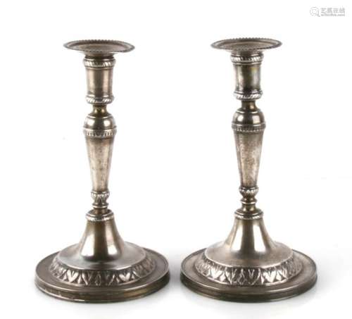 A pair of late 18th century continental, possibly Italian, white metal candlesticks, unmarked but