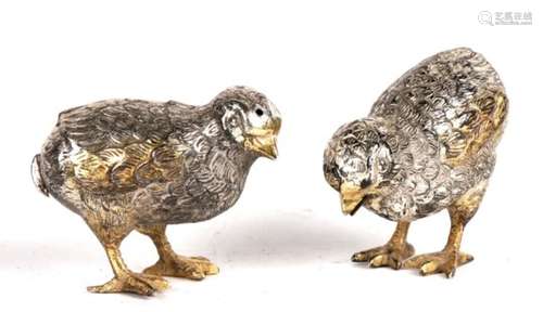 A pair of Italian silver and gilt salt and peppers in the form of quails, 5cms (2ins) high.