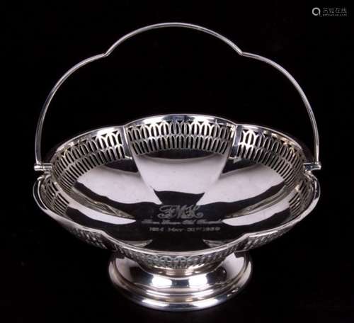 A George V pierced silver fruit basket of circular lobed form with swing handle. Birmingham 1928.