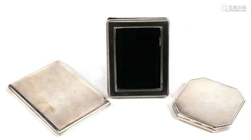 A group of silver compacts.