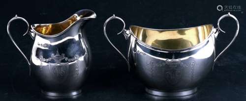 A silver milk jug and sugar bowl with engraved decoration, Birmingham 1912.