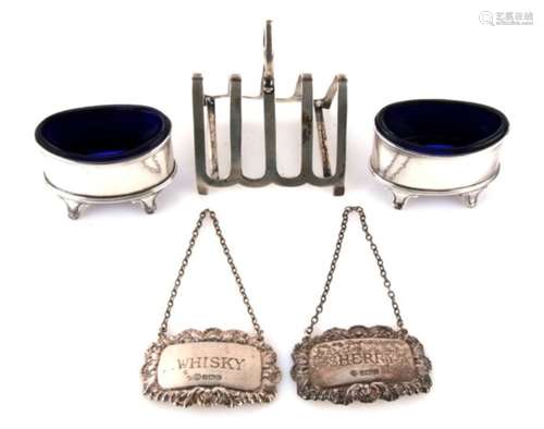 A pair of silver salts with blue glass liners; together with a silver four-division toast rack and