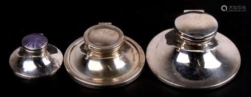 Collection of three silver capstan inkwells. The smallest with purple Guilloche enamel lid. The