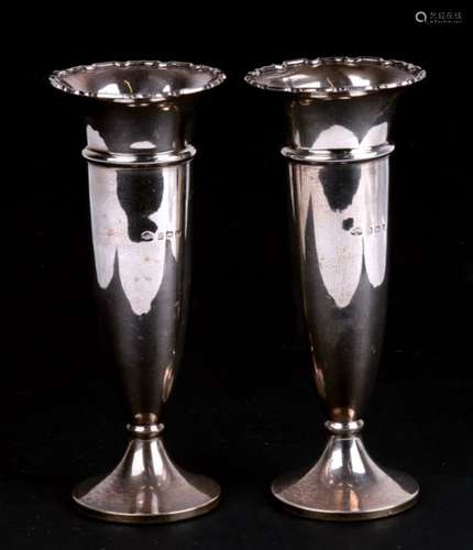 A pair of flared silver vases, with ornate rims. Birmingham 1930 15.5cm (6 ins) high