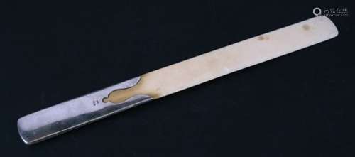 A silver handled ivory page turner, London 1909. 33cm (13 ins) long