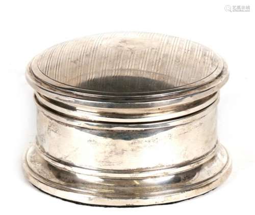 A round silver dressing table box with padded lid and blank cartouche, Birmingham 1925. weight 543g.