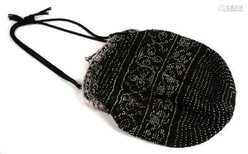 An early 20th century black evening bag, set with cut steel and mounted upon a silver framework,