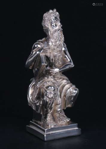 A silver figure depicting the statue of Moses by Michelangelo, the original in the church of San