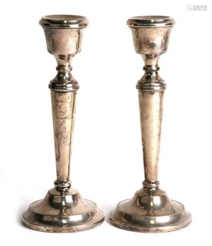 A pair of circular silver candlesticks of tapering form, Birmingham 1972, makers mark A.T.C., 20.