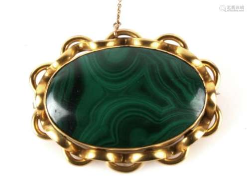 A Victorian gilt metal and malachite brooch, 6cms (2.25ins) wide.