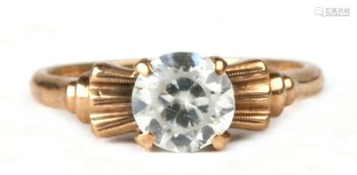 A 10ct gold dress ring set with a single large white stone, possible a white sapphire, approx UK