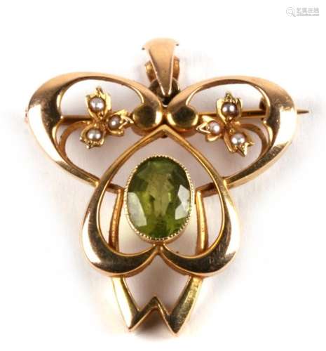 An Art Nouveau 15ct gold pendant brooch set with pearls and central green peridot, 6g. 3.5cms (1.