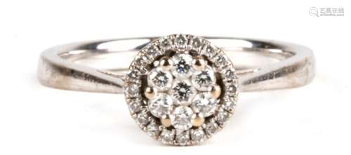 An 18ct white gold diamond cluster ring, approx UK size 'M'.