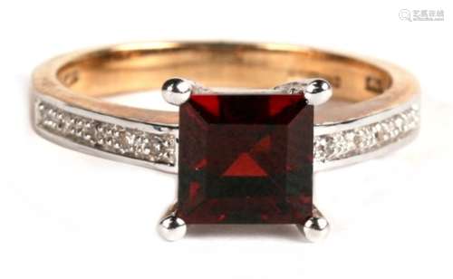 A 9ct gold garnet and diamond ring, the central square cut garnet with diamond shoulders, approx