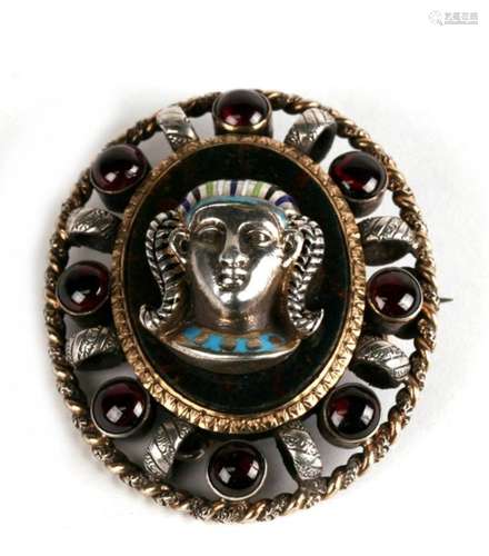 An Egyptian Revival silver enamel and cabochon garnet set brooch, 5cms (2ins) high.